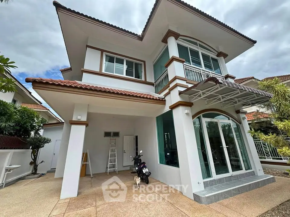 Elegant two-story house with modern design and spacious driveway in a serene neighborhood.