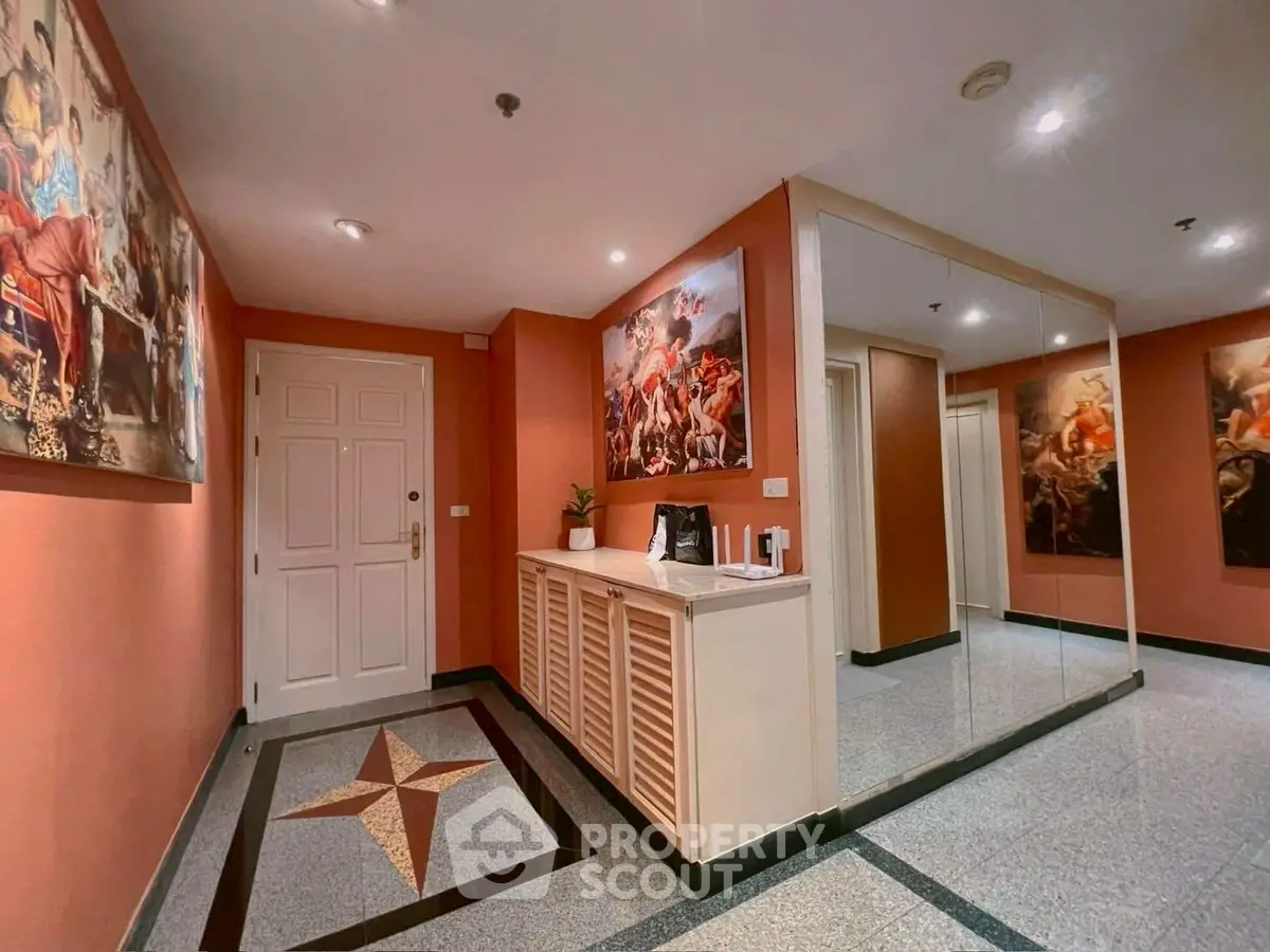 Elegant apartment entrance with artistic decor and large mirror
