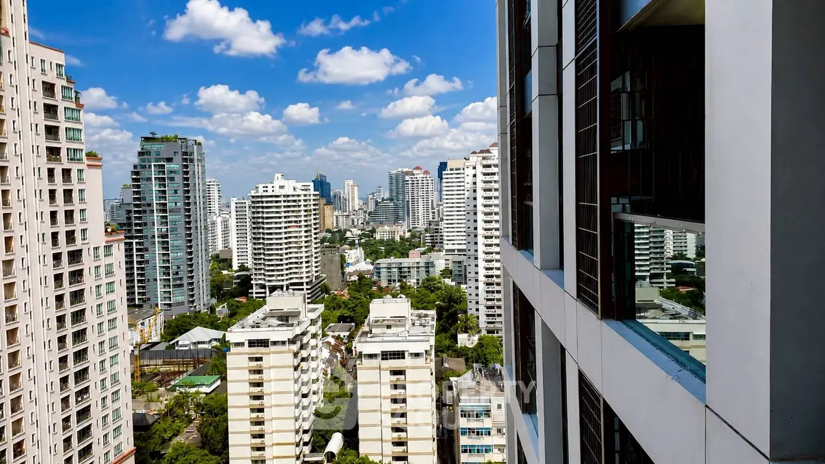 Stunning cityscape view from a high-rise building balcony, showcasing modern urban living.