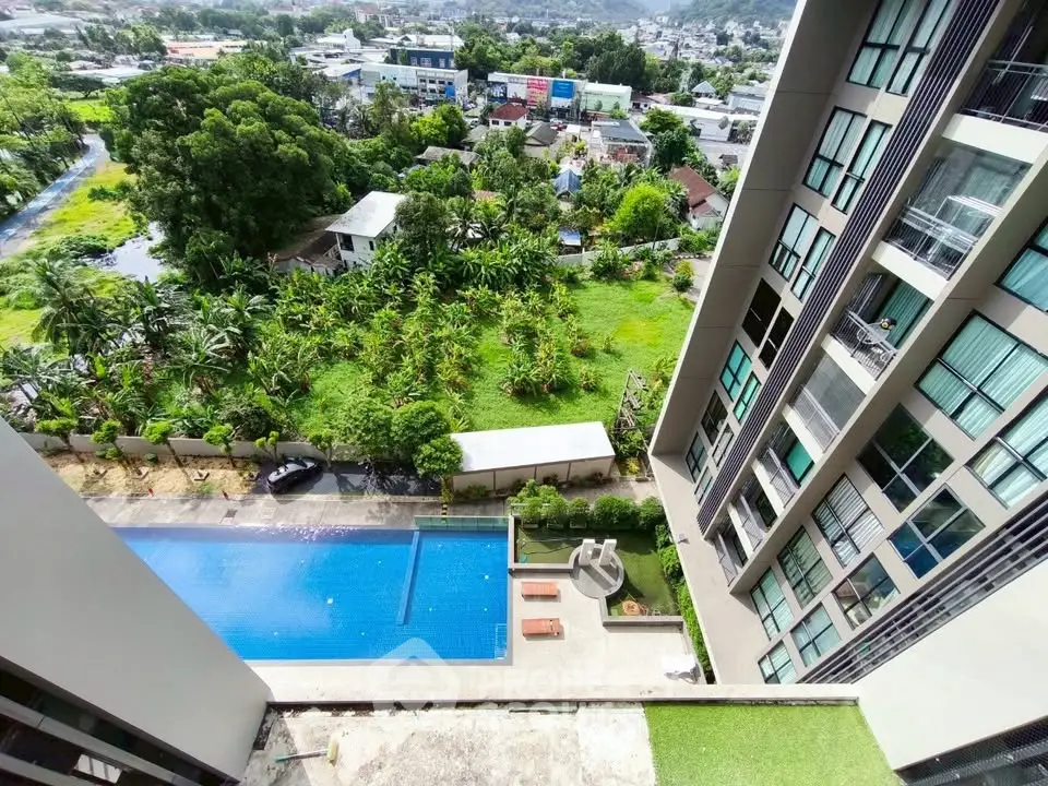 Stunning high-rise apartment view with pool and lush greenery, perfect for urban living.