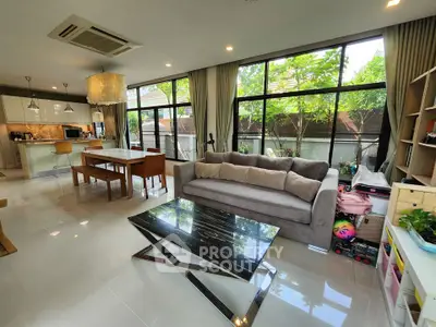 Spacious modern living room with large windows and elegant decor