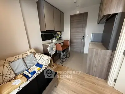 Modern compact living room with stylish kitchen and cozy seating area