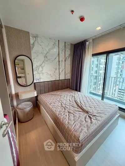 Modern bedroom with stylish decor and city view balcony in a high-rise apartment.