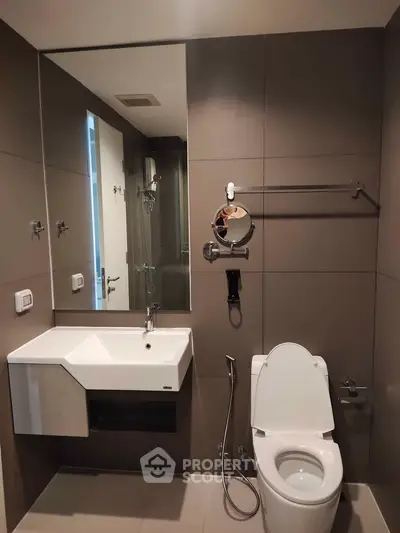 Modern bathroom with sleek fixtures and large mirror