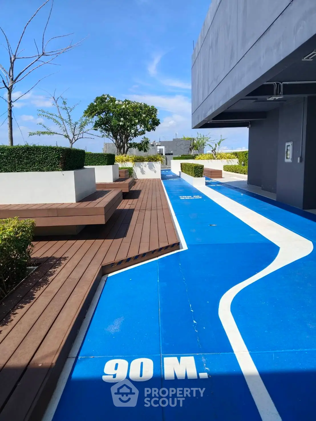 Modern rooftop with jogging track and seating area in urban building