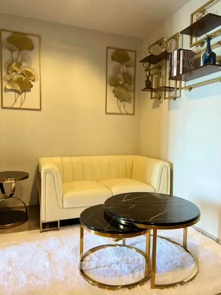 Elegant living room with chic decor, featuring a plush sofa and stylish coffee tables, perfect for modern living.