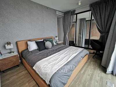 Modern bedroom with stylish decor and large windows offering natural light