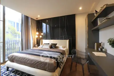 Luxurious modern bedroom with elegant decor and large windows offering natural light.
