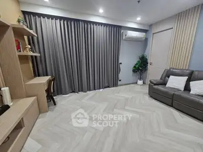 Modern living room with sleek furniture and stylish flooring, featuring a cozy sofa and elegant curtains.