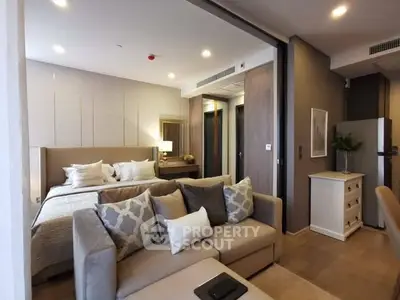 Luxurious modern bedroom with cozy seating area and stylish decor