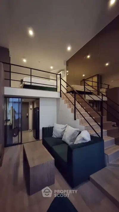 Modern loft apartment with stylish mezzanine bedroom and cozy living area.