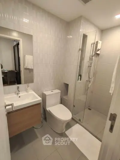 Modern bathroom with sleek design, glass shower, and contemporary fixtures.