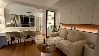 Modern living room with cozy sofa and stylish decor, featuring a sleek open layout and ambient lighting.