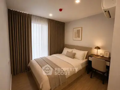 Cozy bedroom with modern decor and natural light, featuring a comfortable bed and stylish furnishings.