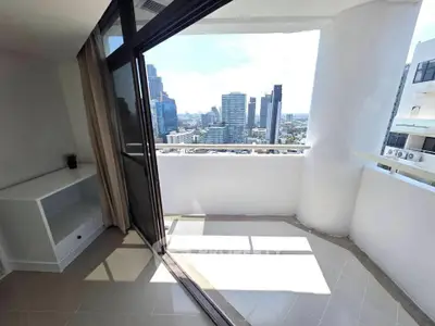 Spacious balcony with stunning city view in modern high-rise apartment