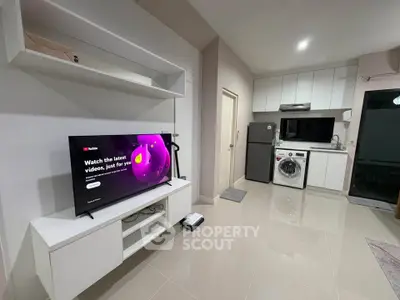 Modern open-layout kitchen with sleek appliances and integrated living area