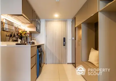 Modern compact kitchen with washing machine and sleek cabinetry