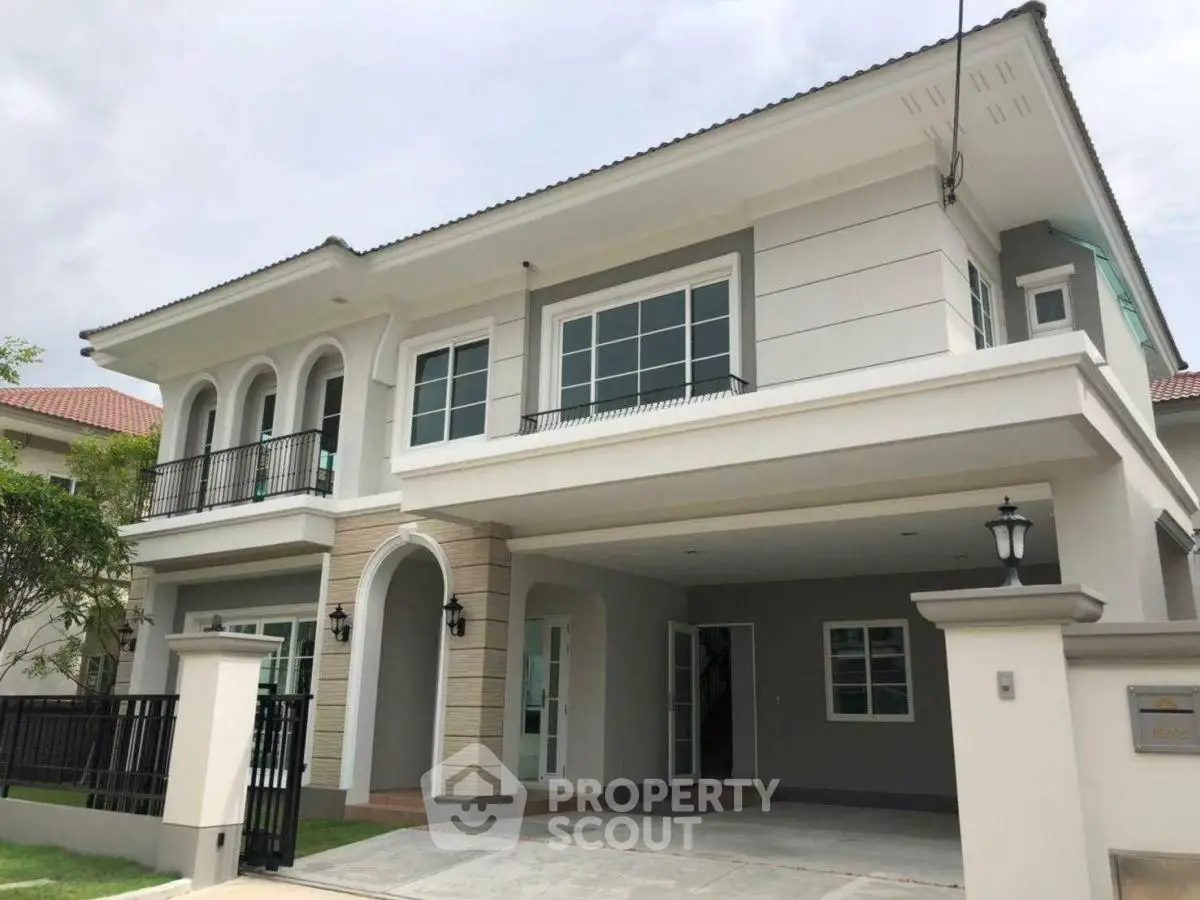 Elegant two-story house with modern facade and spacious driveway in a serene neighborhood.