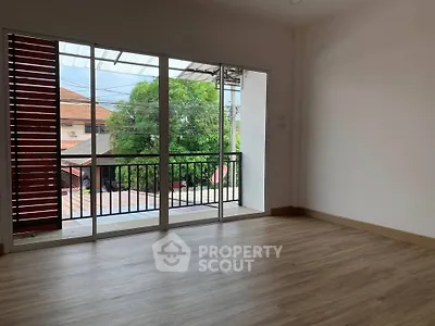 Spacious room with large windows and balcony view, perfect for natural light lovers.