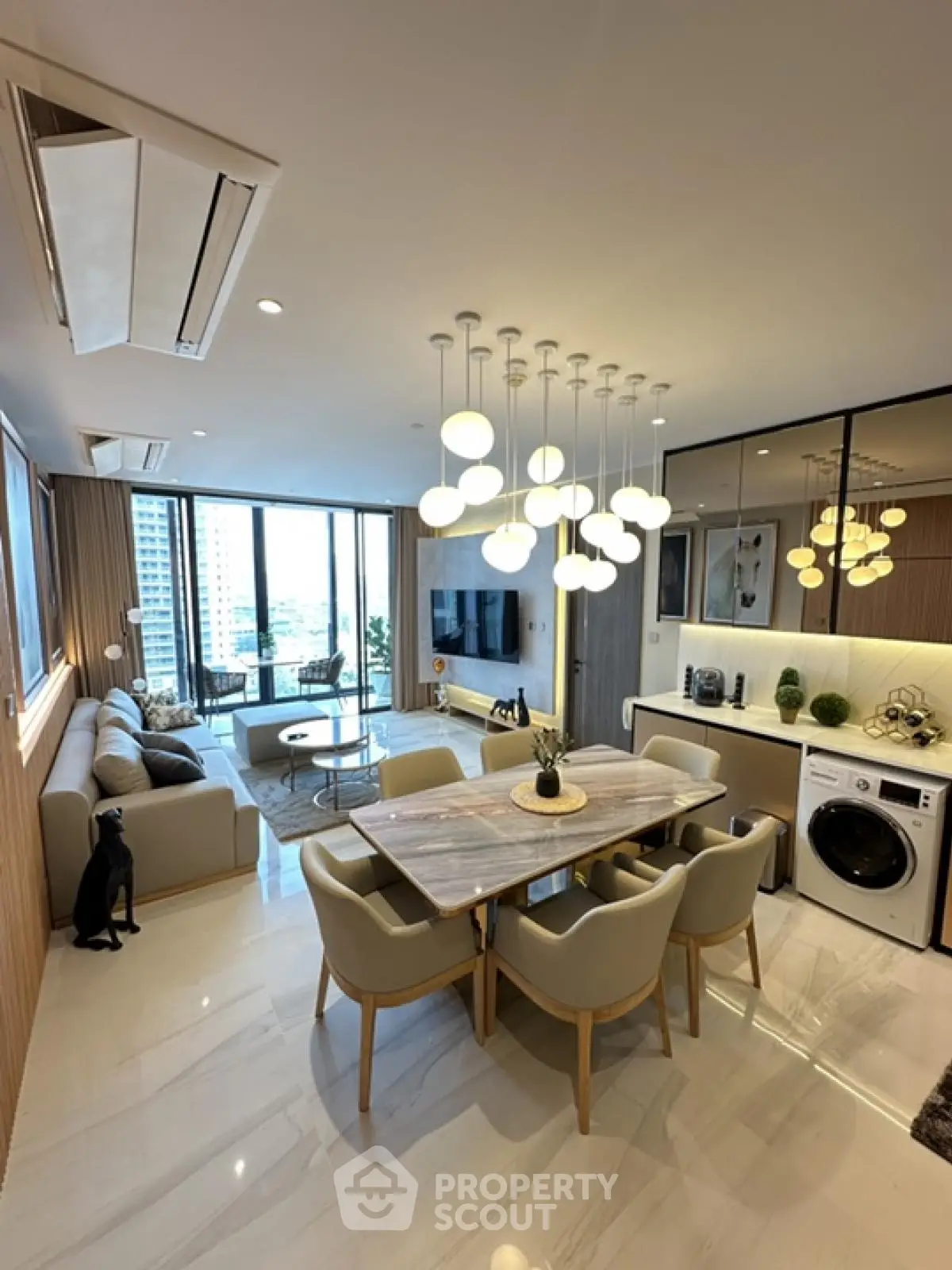 Luxurious open-plan living and dining area with modern decor and large windows