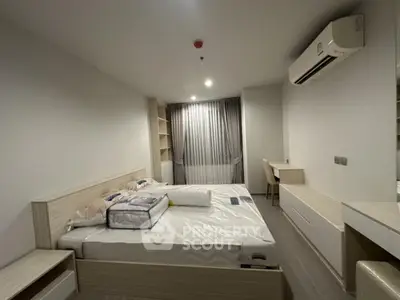 Modern bedroom with built-in furniture and air conditioning in a stylish apartment.