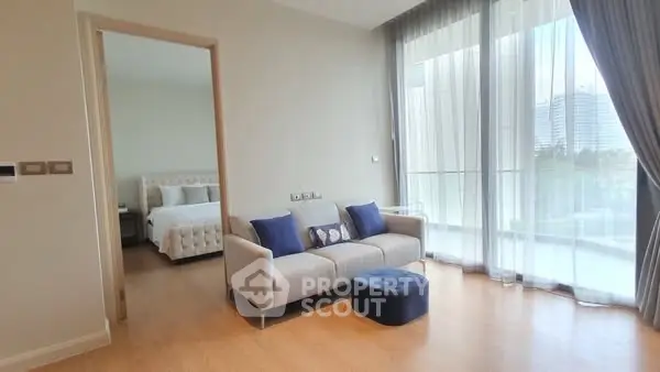 Modern living room with natural light and bedroom view