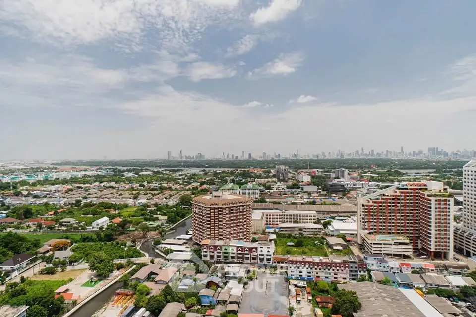 Stunning panoramic cityscape view from high-rise building, showcasing urban skyline and lush greenery.