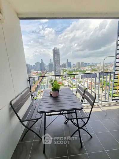 Stunning balcony view with modern cityscape, perfect for relaxation and outdoor dining.