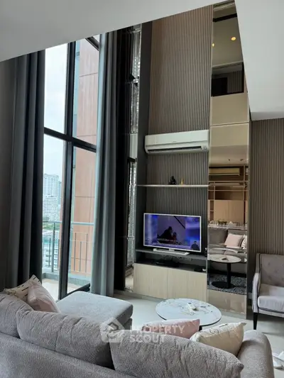 Luxurious modern living room with floor-to-ceiling windows and elegant decor in a high-rise apartment.