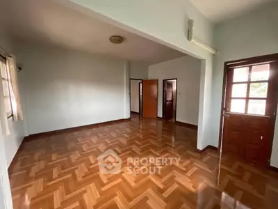 Spacious empty living room with wooden flooring and natural light