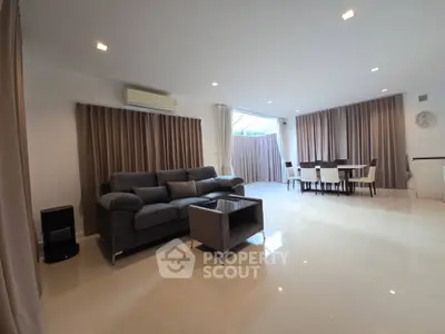 Spacious modern living room with elegant dining area and natural light