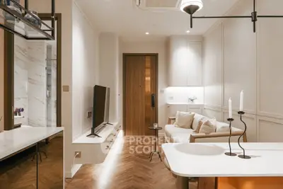 Elegant modern living room with stylish decor and open layout, featuring a cozy sofa and sleek TV setup.