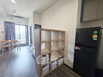 Modern apartment interior with open layout, featuring a cozy living area and stylish kitchen.