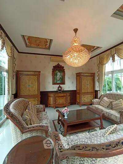 Luxurious living room with elegant chandelier and classic furniture, perfect for sophisticated gatherings.