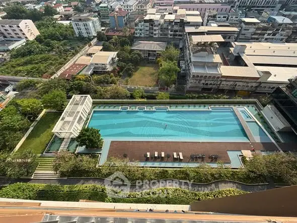 Stunning aerial view of a luxurious rooftop pool in an urban setting, perfect for relaxation and leisure.