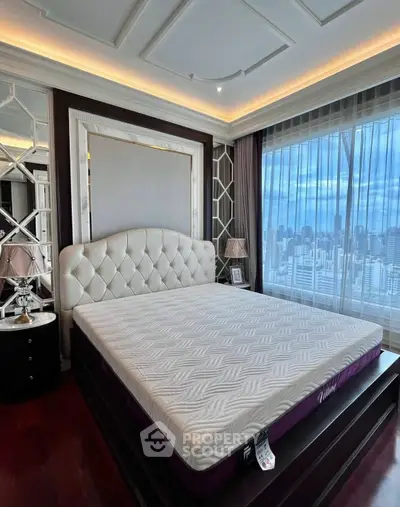 Luxurious bedroom with elegant decor and stunning city view from large windows.