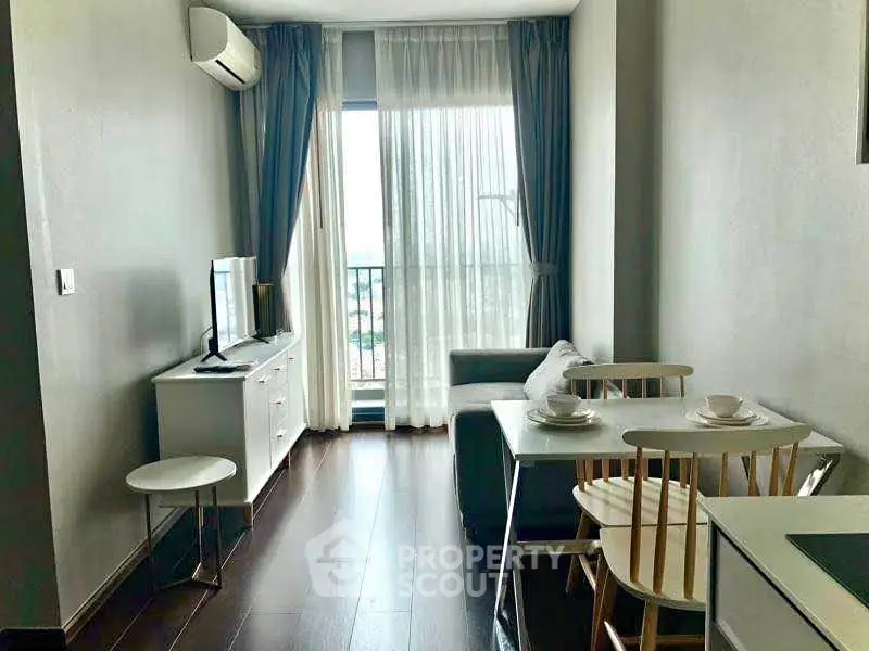 Modern living room with natural light and stylish furniture in a cozy apartment.