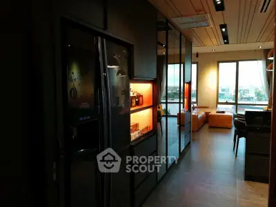 Modern apartment interior with sleek kitchen and spacious living area featuring large windows.