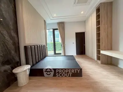 Spacious modern bedroom with elegant design and large window view