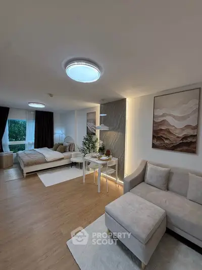 Spacious modern studio apartment with cozy living area and stylish decor