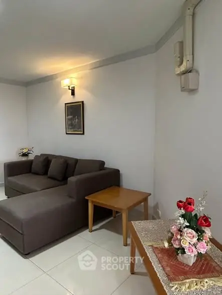Cozy living room with modern sofa and elegant decor, perfect for relaxation and entertaining guests.