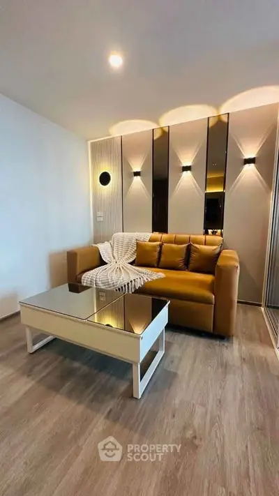 Modern living room with stylish sofa and mirrored wall accents