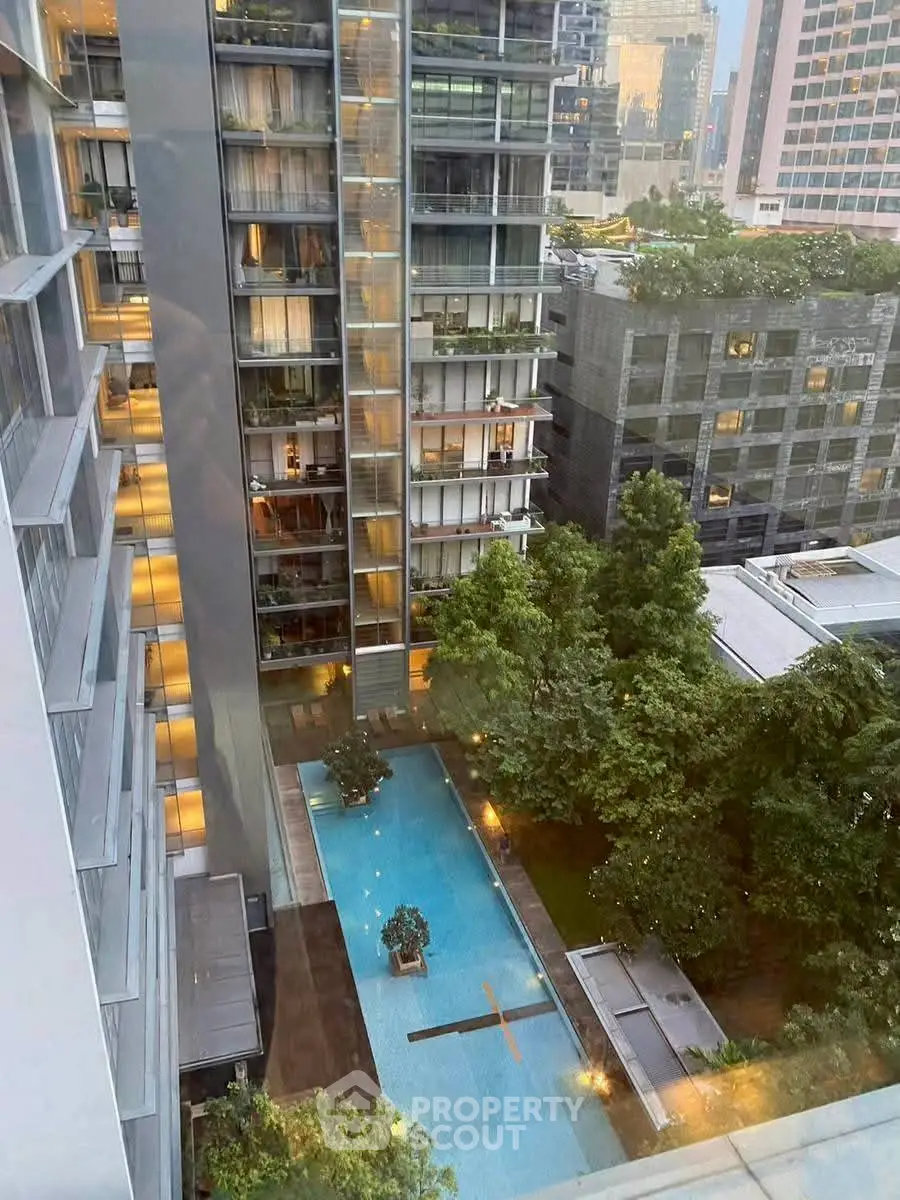Stunning high-rise view with pool and lush greenery in urban setting