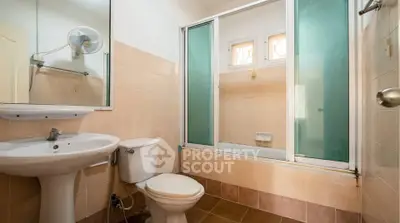 Spacious bathroom with bathtub and modern fixtures in a well-lit setting.
