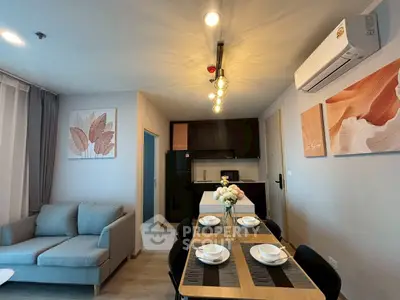 Modern living room with stylish decor and dining area in open layout apartment.