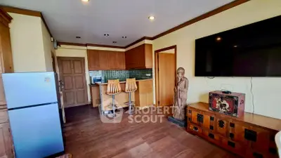 Charming living room with wooden floors, modern kitchen, and stylish decor in a cozy apartment.
