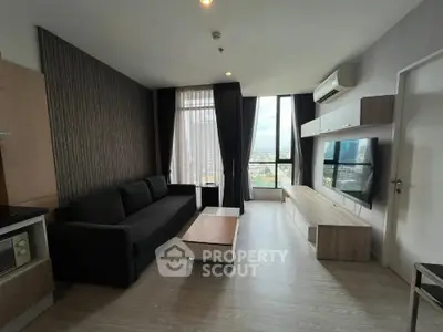 Modern living room with sleek furniture and city view, ideal for urban living.