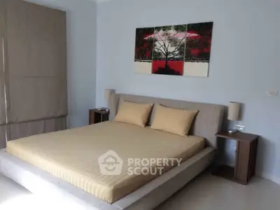 Elegant bedroom with modern decor and stylish artwork above bed