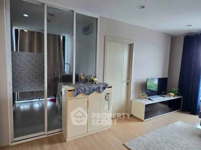 Modern living room with stylish decor and washing machine in a sleek cabinet.