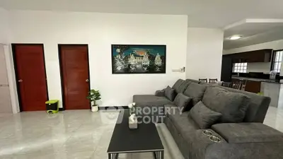 Spacious living room with modern gray sofa and elegant decor in a stylish home.